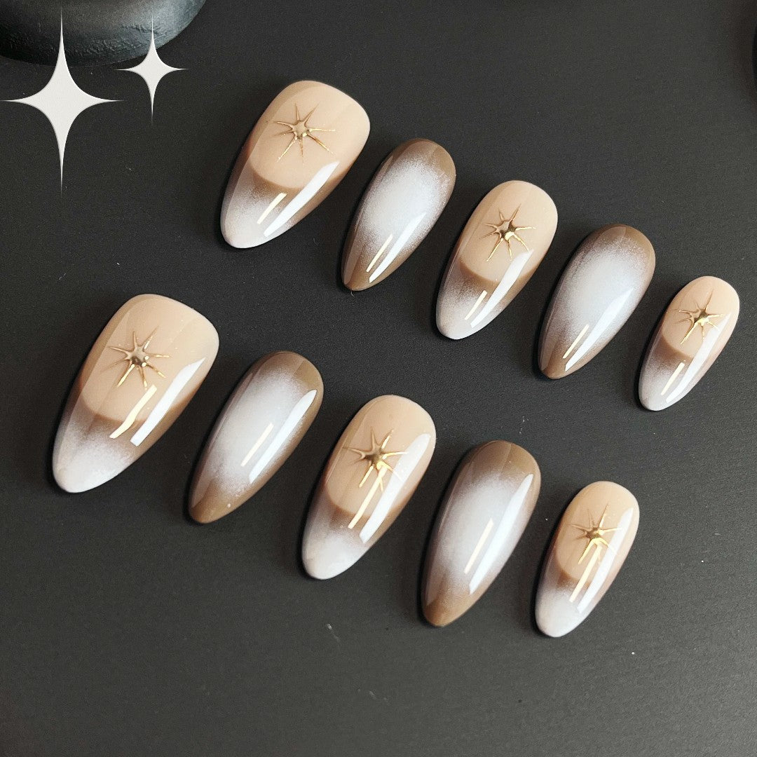 Eclipse Glow press on nails featuring a chic ombre gradient and delicate gold chrome stars