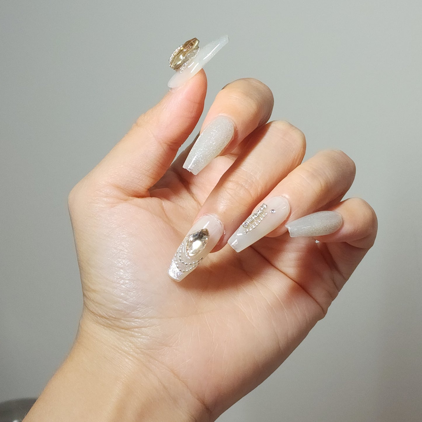 Glitz Heart press-on nails from Yitaya, featuring a shimmering white base with gold accents and dazzling rhinestones