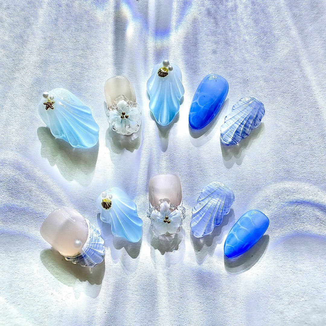 Seaside Elegancel Press On Nails from Yitaya Nails -- featuring a mesmerizing blend of soft blues and whites, adorned with crescent moons, stars, and clouds