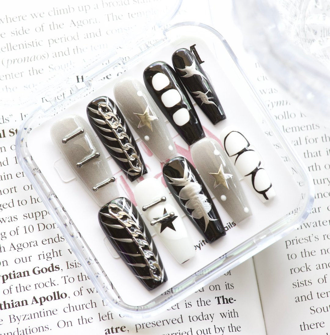 Starlit Noir Press On Nails, featuring a striking blend of black, white, and metallic accents
