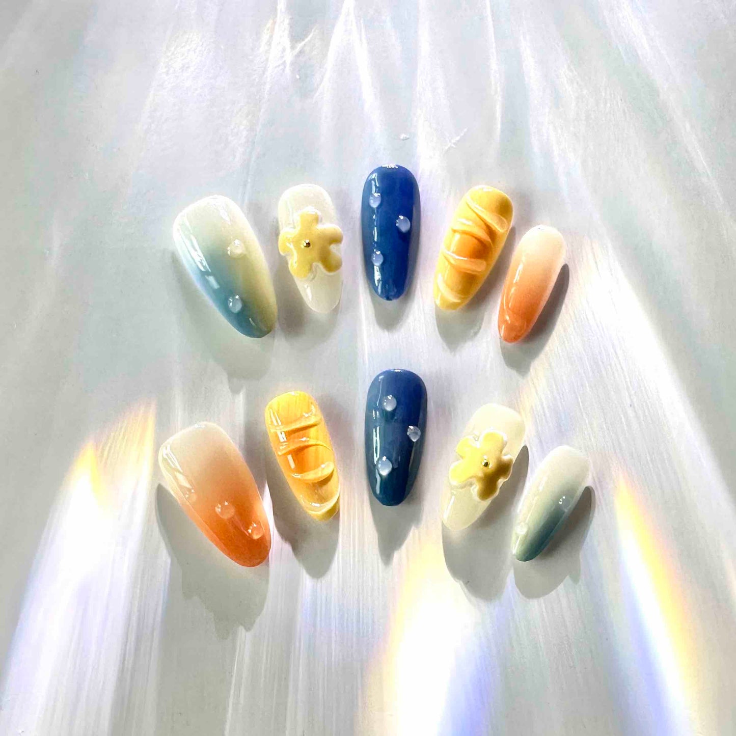 Summer Vibes Press On Nails from Yitaya Nails -- capturing the essence of summer with a beautiful gradient of blue and orange colors, reminiscent of the ocean and the setting sun