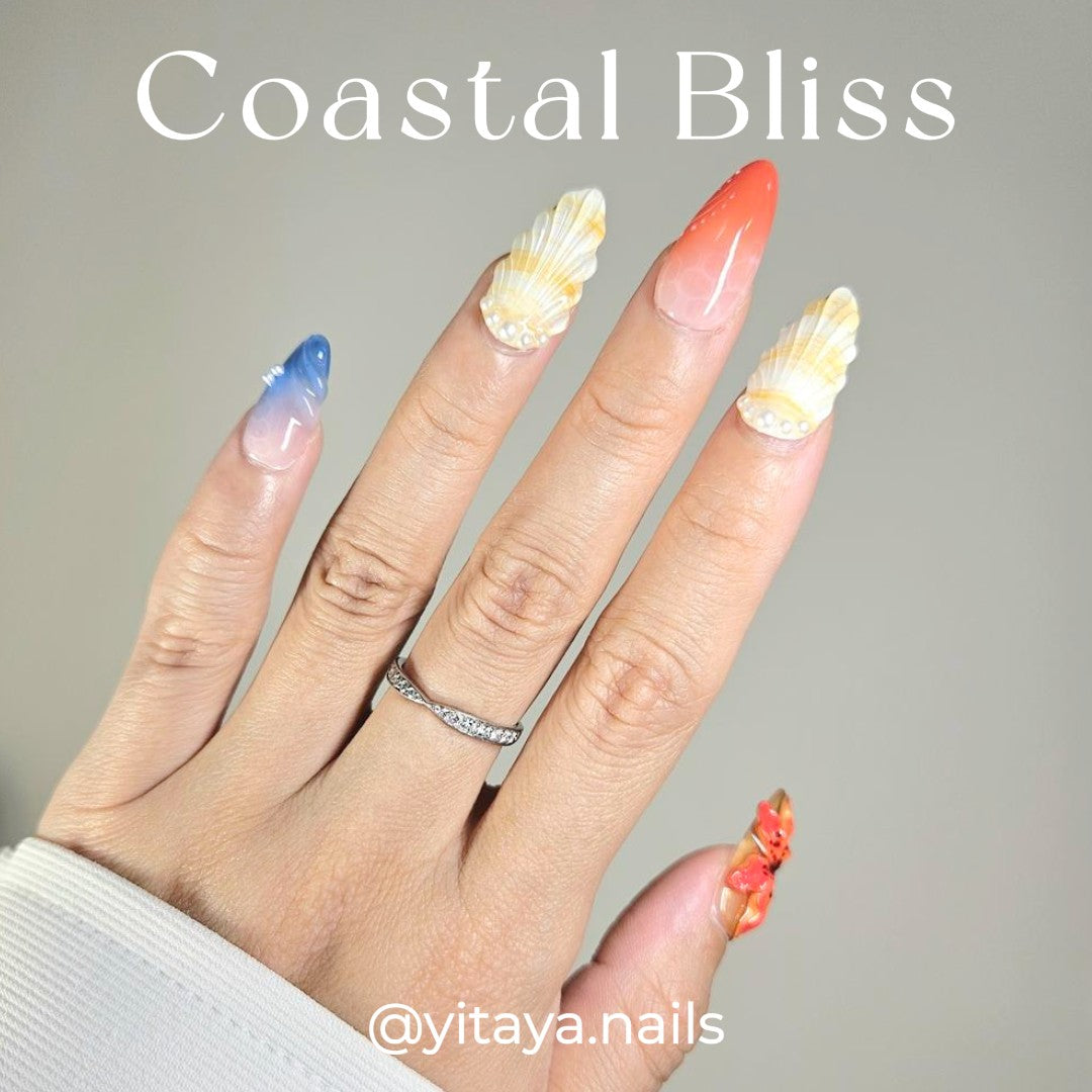 3D Coastal Bliss Press On Nails, feature exquisite shell details, soft ombré blues, corals, and delicate floral accents