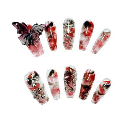 Crucipapillon Press On Nails from Yitaya, featuring a striking marbled pattern in shades of red, black, and white, creating a dynamic and eye-catching effect