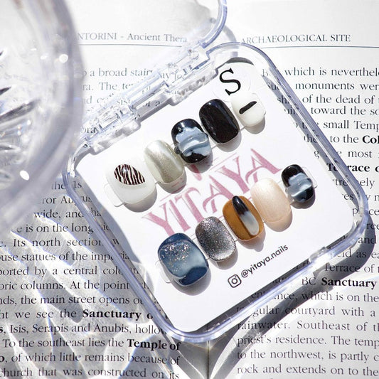 Earthbound Luxe Press On Nails, featuring a mix of earthy tones, abstract patterns, and shimmering accents