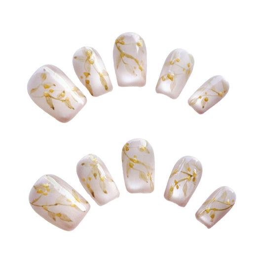 Golden Blossom press on nails, featuring soft pearly white tones adorned with intricate golden floral designs