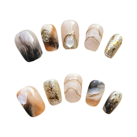 Golden Sands Short Press On Nails, featuring a chic blend of soft beige, smokey marble swirls, and shimmering gold accents