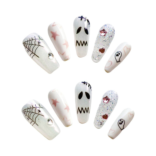 Spooky Stardust Glow press-on nails, featuring a playful mix of ghostly faces, shimmering spider webs, and pastel stars