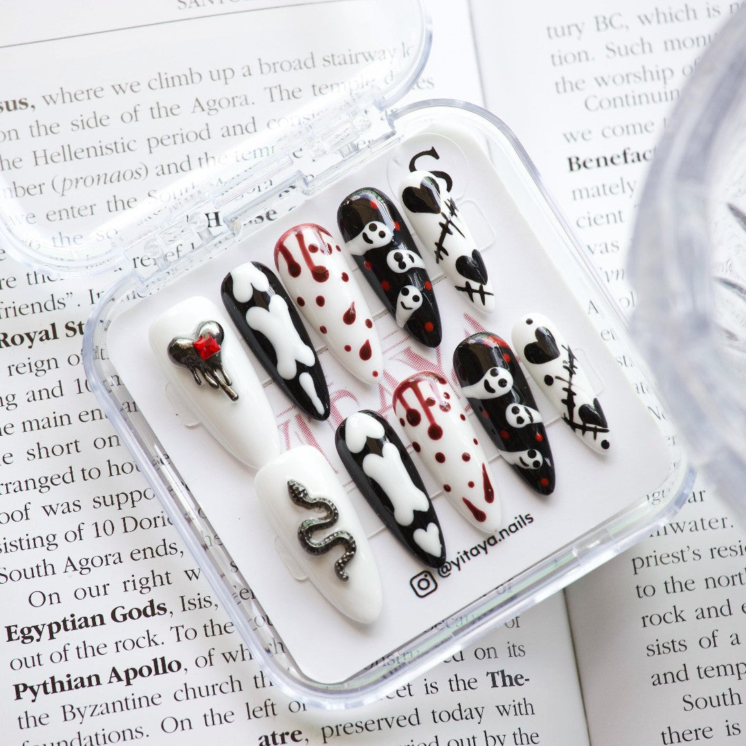 Spooky Vibes Press On Nails, featuring eerie designs like skulls, bones, stitched hearts, and dripping blood