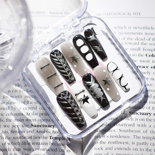 Starlit Noir Press On Nails, featuring a striking blend of black, white, and metallic accents