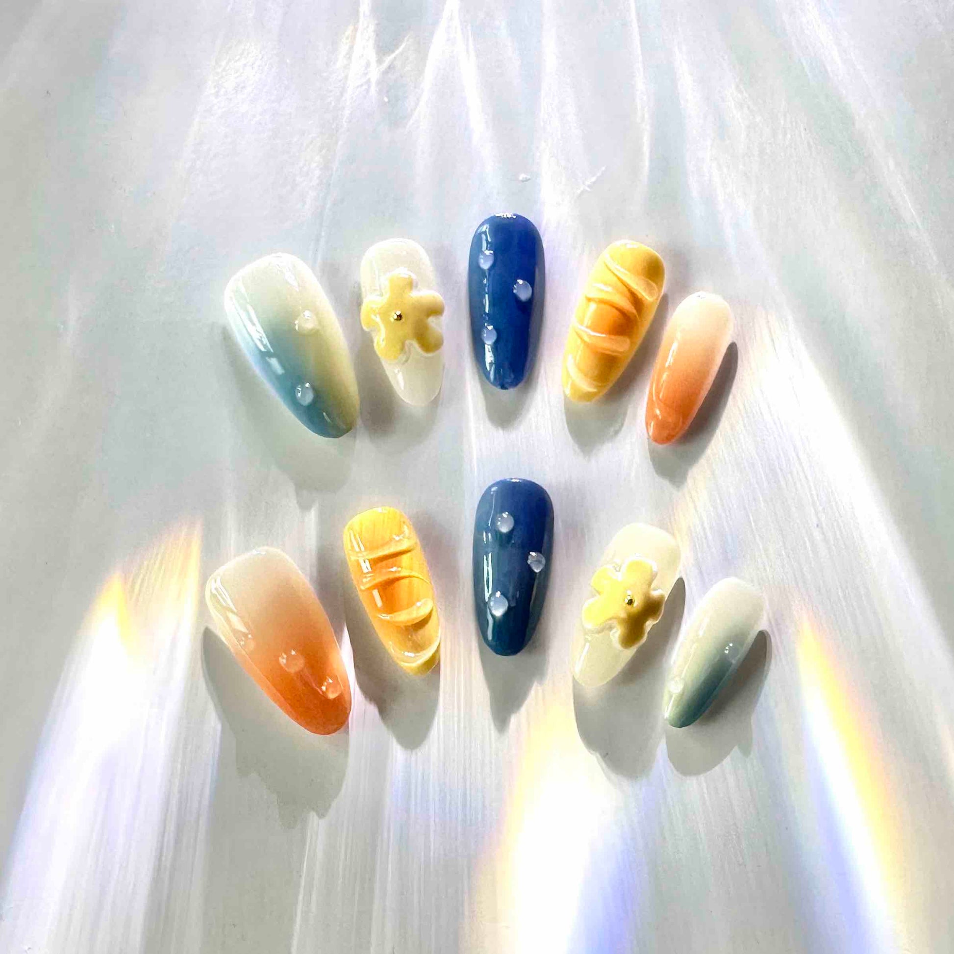 Summer Vibes Press On Nails from Yitaya Nails -- capturing the essence of summer with  a beautiful gradient of blue and orange colors, reminiscent of the ocean and the setting sun