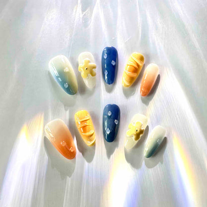 Summer Vibes Press On Nails from Yitaya Nails -- capturing the essence of summer with  a beautiful gradient of blue and orange colors, reminiscent of the ocean and the setting sun