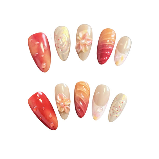 Sunset Bloom Press On nails from Yitaya Nails, featuring features a blend of warm reds, oranges, and golden tones