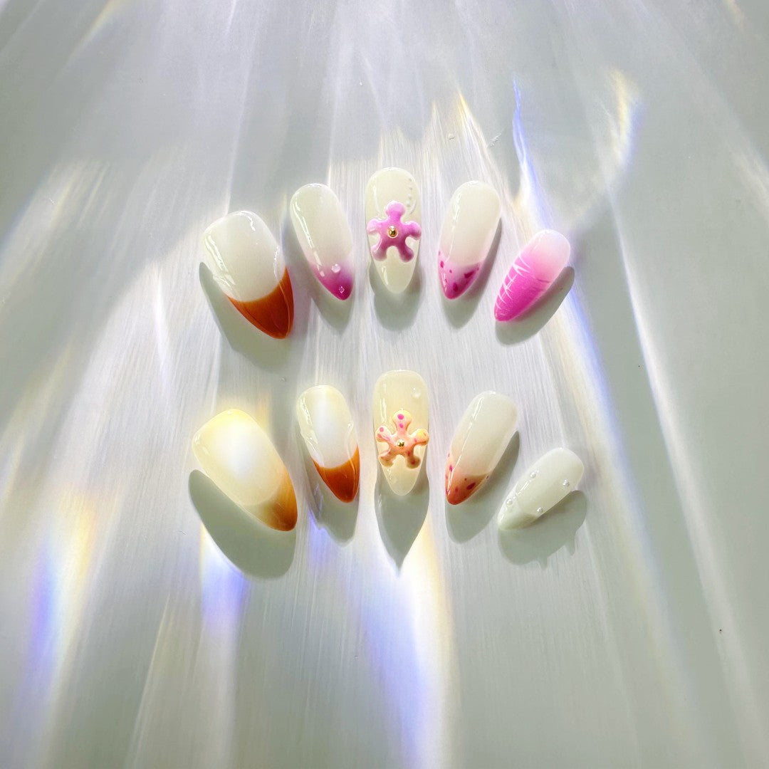 Sunset Sorbet Delight gel nails, featuring shades of orange, pink, and purple, with 3D floral accents