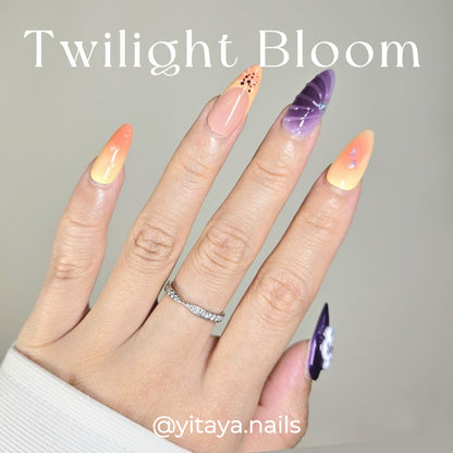 Twilight Bloom Press On Nails, blending purples, oranges, and nudes with floral accents and rhinestone